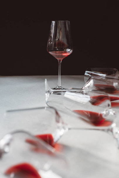 Glasses of red  wine  on white and dark background,  copy space.  Wine degustation concept - Foto, Imagen