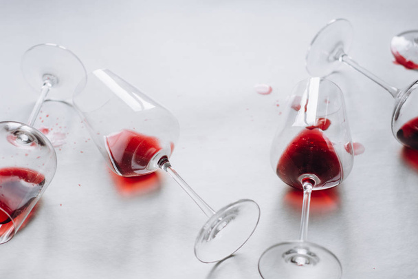 Glasses of spilled red  wine  on white  background,  copy space.  Wine degustation concept - 写真・画像