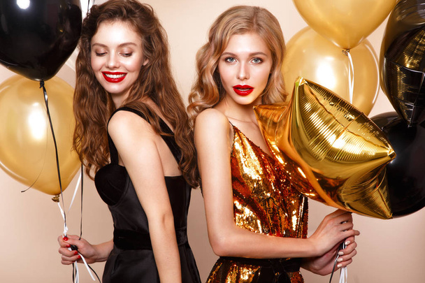Beautiful young girls in elegant evening dresses with festive balloons. Beauty face. - Foto, Imagem