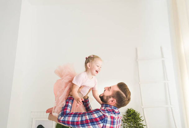 Cute little girl and her dad are having fun at home. - Foto, Bild