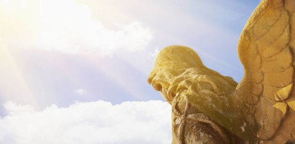 golden angel in the sunlight (antique statue) - Photo, Image