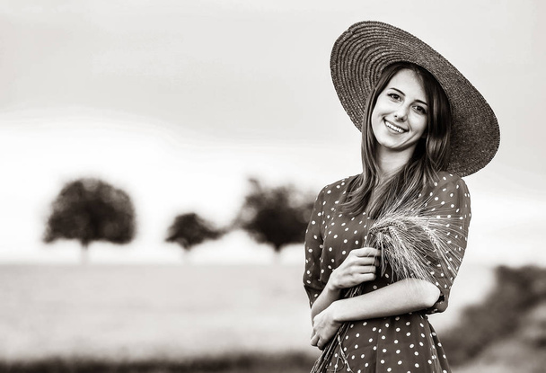 farm girl holding wheat ears on a field - Photo, Image