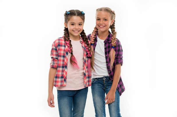 Girls friends wear similar outfits have same hairstyle kanekalon braids white background. Sisters family look outfit. Dress similar with best friend. Dress to match your friend. Best friend dressing - Fotoğraf, Görsel