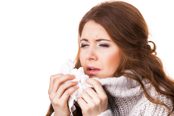 Sick freezing woman sneezing in tissue. Girl wearing warm sweater being cold and trembling. Flu or other virus. Health care. - Photo, Image