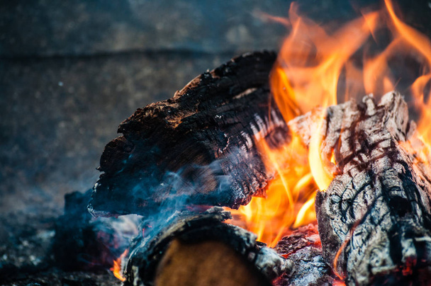 Bonfire logs in flames outside at winter on ski resort, close up - Φωτογραφία, εικόνα