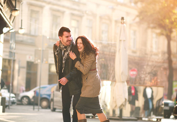 Romantic happy young couple in love in a tourist city having fun together in sunset light - Foto, Imagen
