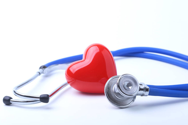 Medical stethoscope and red heart isolated on white. - Фото, зображення