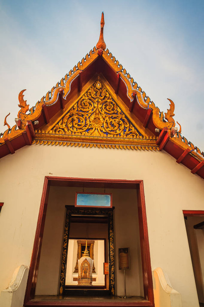 Beautiful golden artwork on the gable end and golden pillar of buddhist church in Wat Saket Ratcha Wora Maha Wihan (Wat Phu Khao Thong, Golden Mount temple), a popular Bangkok tourist attraction. - Photo, image