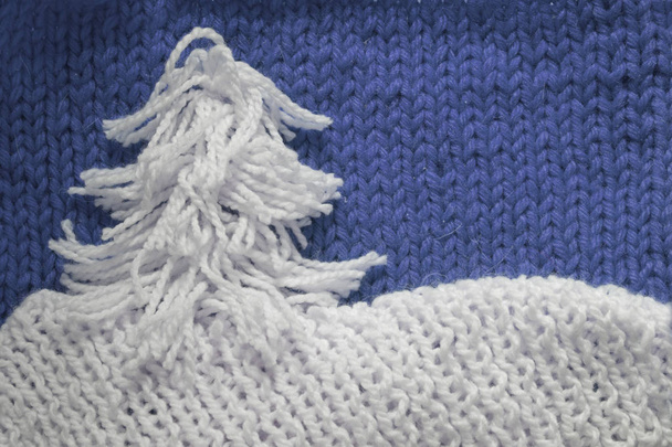 Hadmade Christmas tree on blue knitted woolen background with copy space for text Christmas concept - Foto, Bild