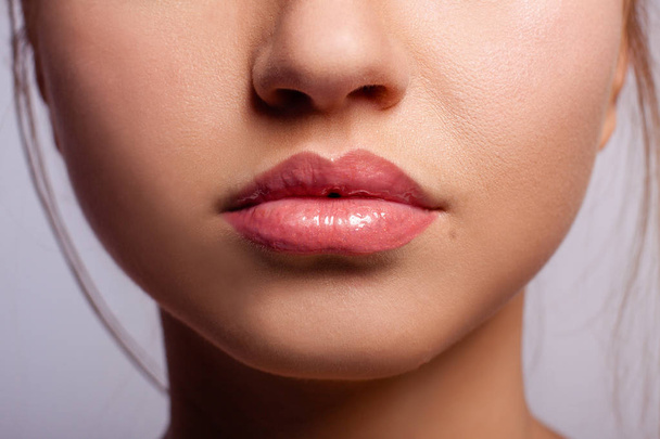 Beautiful lips of the young girl, with the lipstick applied on them - Foto, Imagem