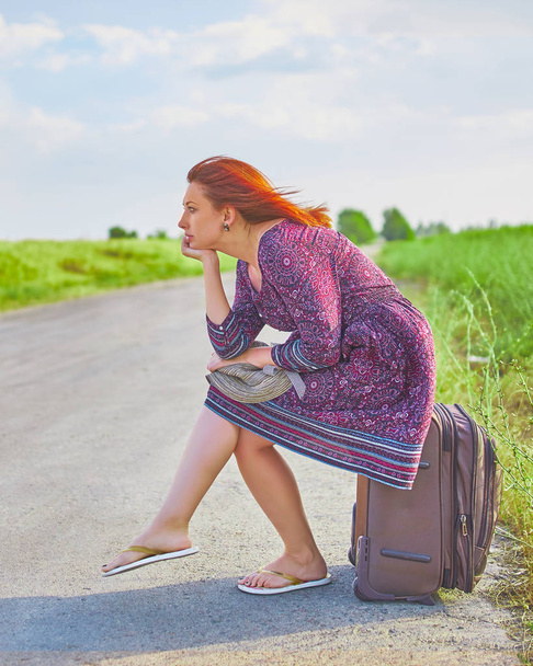 Woman sits on baggage - Photo, Image
