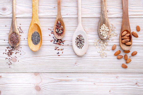 Different types of grains and cereals on shabby wooden background. - 写真・画像