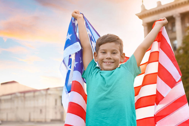 Cute little boy with American flag on city street - Fotó, kép