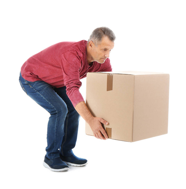 Full length portrait of mature man lifting carton box on white background. Posture concept - Fotoğraf, Görsel