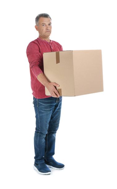 Full length portrait of mature man carrying carton box on white background. Posture concept - Fotoğraf, Görsel