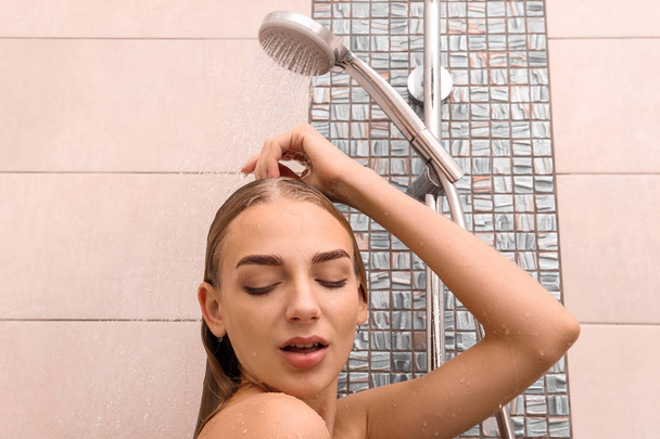 Beautiful young woman taking shower at home - Zdjęcie, obraz