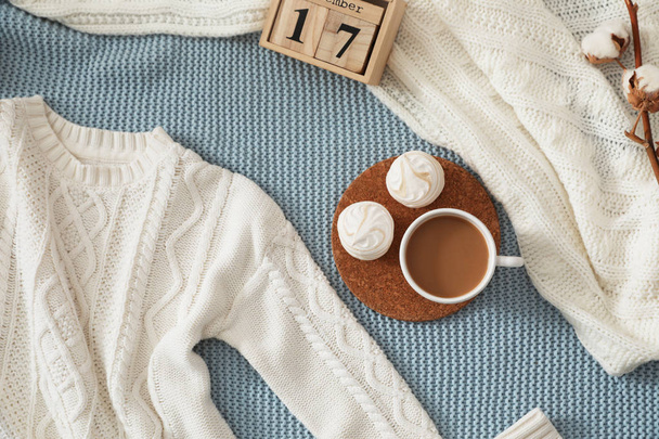 Flat lay composition with cozy knitted sweater on blanket - Photo, Image
