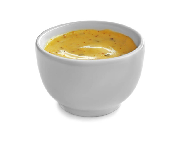 Savoureuse sauce jaune dans un bol sur fond blanc
 - Photo, image