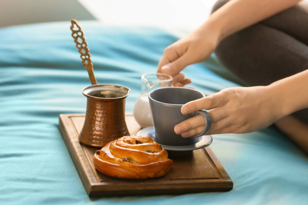Young woman having delicious breakfast on bed - Photo, Image