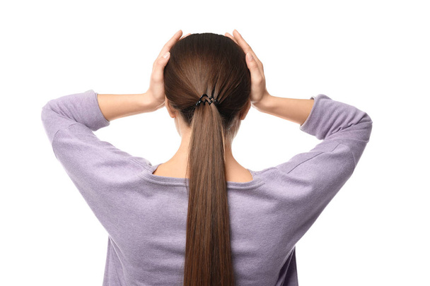Woman suffering from headache on white background, back view - Фото, зображення
