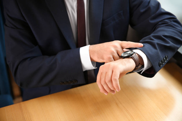Businessman looking at his watch, closeup - Photo, Image