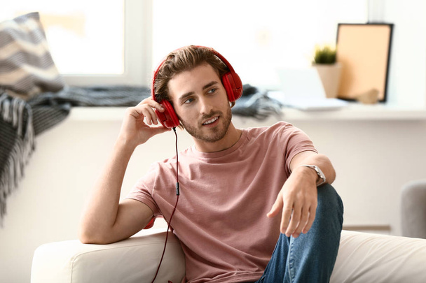 Young man listening to music at home - Foto, imagen