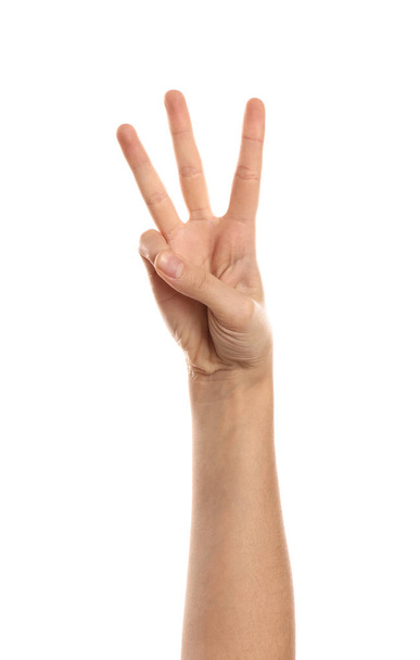 Mano femenina mostrando tres dedos sobre fondo blanco
 - Foto, imagen