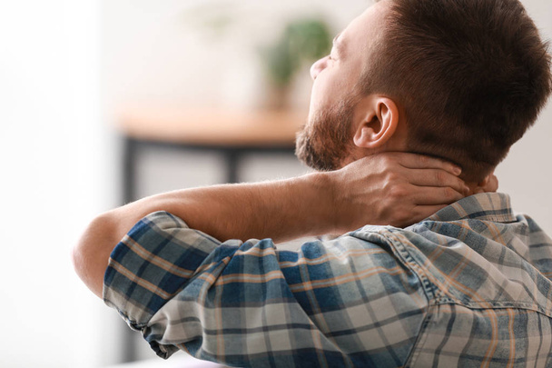 Man suffering from neck pain at home - Φωτογραφία, εικόνα