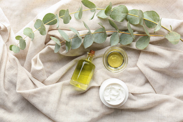 Cosmetics with eucalyptus extract on light cloth - Фото, изображение
