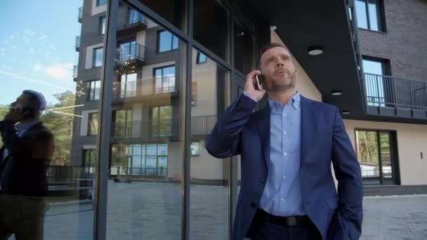 Successful man near business center speak at phone - Felvétel, videó