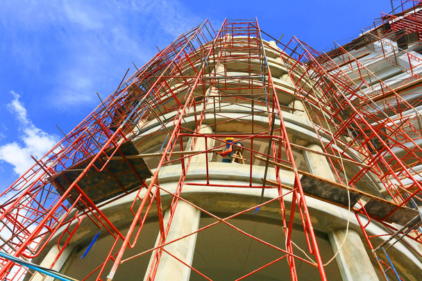 construction site with scaffolding in city - Fotó, kép