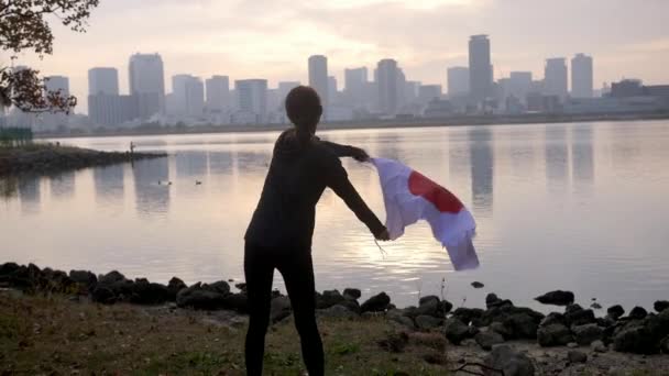 Japanese flag being excitedly draped around proud young woman, HD, slow motion. - Πλάνα, βίντεο