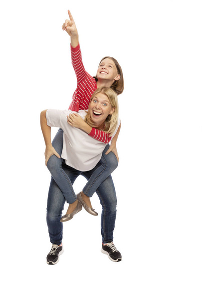 Mom with her teenager daughter hugging and laughing, white background - Foto, Bild