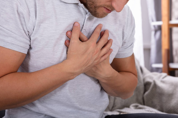Man Touching His Chest While Suffering From Pain - Foto, afbeelding