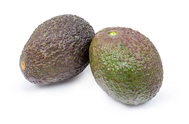 Two avocados with brown and green pebbled skin on a white background - Photo, Image