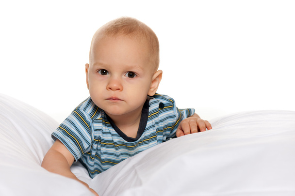 Serious baby boy in the bed - Photo, Image