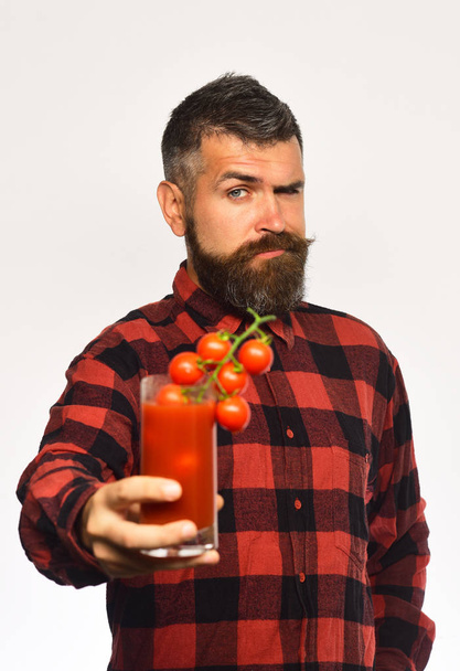 Guy with harvest. Man with beard holds glass of juice - Zdjęcie, obraz