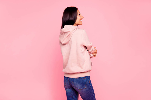 Rear back view of nice cute sweet lovely attractive charming pretty nice-looking cheerful cheery latin girl in sweater jeans isolated over pastel pink background - Foto, immagini