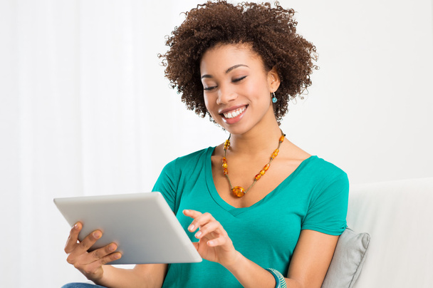 African Woman Looking At Digital Tablet - 写真・画像