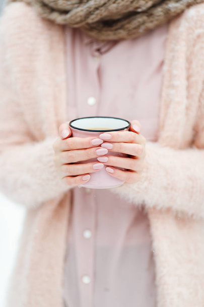 Beautiful female hands holding big pink cup of coffee - 写真・画像