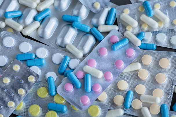 Assorted pharmaceutical packaging of tablets and pills on gray background - Φωτογραφία, εικόνα