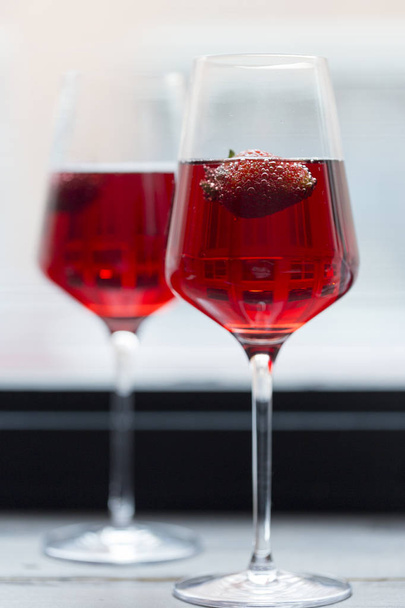 Romantic composition. Strawberry in pink champagne in glasses - Photo, Image