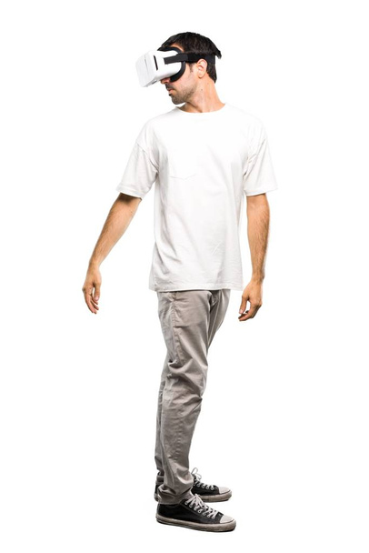 A full-length shot of a Man using VR glasses on isolated white background - Photo, Image