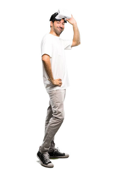 A full-length shot of a Happy man using VR glasses on isolated white background - Photo, Image