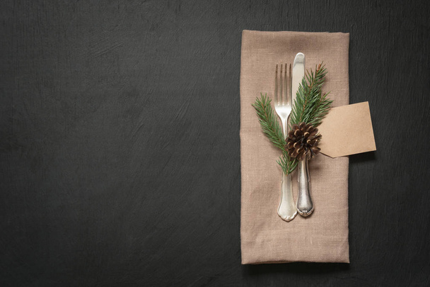 Christmas table place setting with silverware and dark natural evergreen decor. Holiday background. - Φωτογραφία, εικόνα