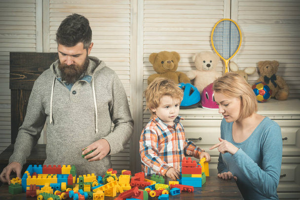 father and mother with child play constructor. little boy play with parents at home. happy childhood. Care and development. happy family and childrens day. Little boy with dad and mom. Our future - Фото, изображение