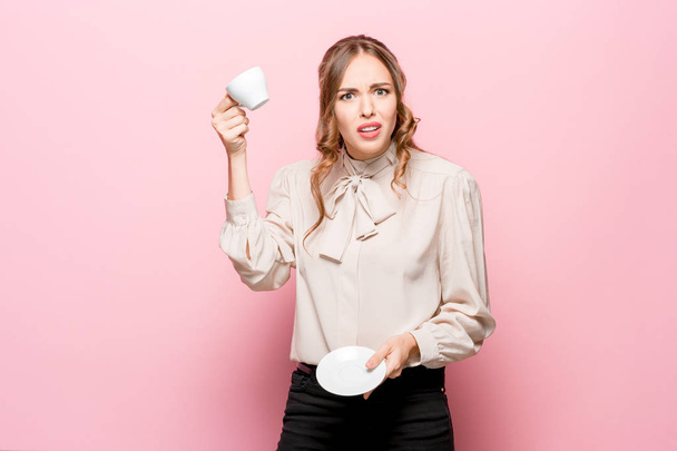 The serious frustrated young beautiful business woman on pink background - Foto, immagini