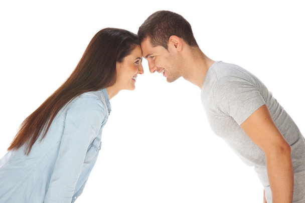 Young couple staring at each other and smiling - Foto, Imagen