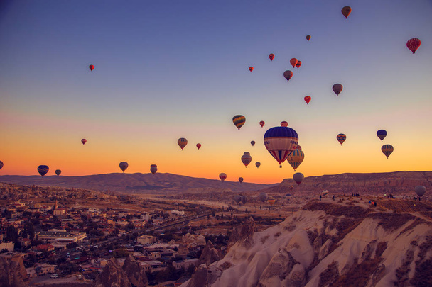 Central Anatolia, Goreme, Turkey - September 22, 2018. Amazing sunrise over Cappadocia. Colorful hot air balloons.  - Фото, изображение