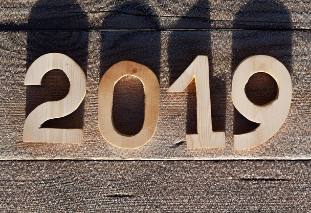 Wooden number 2019 on wooden background. Happy new Year 2019. - Foto, afbeelding